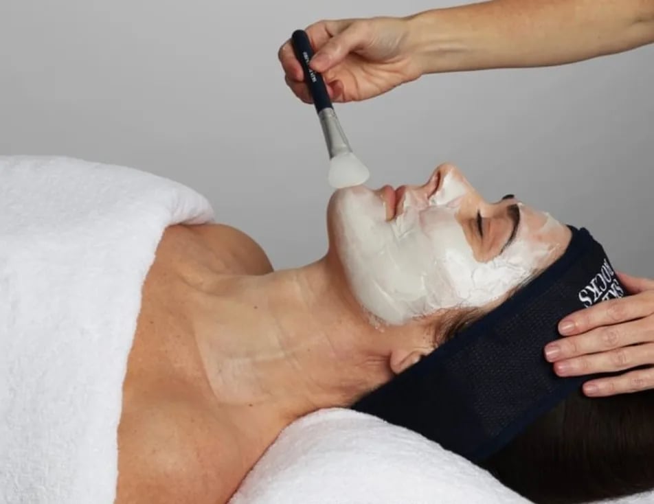 A treatment mask being brushed on during a facial at Face Club Amsterdam.