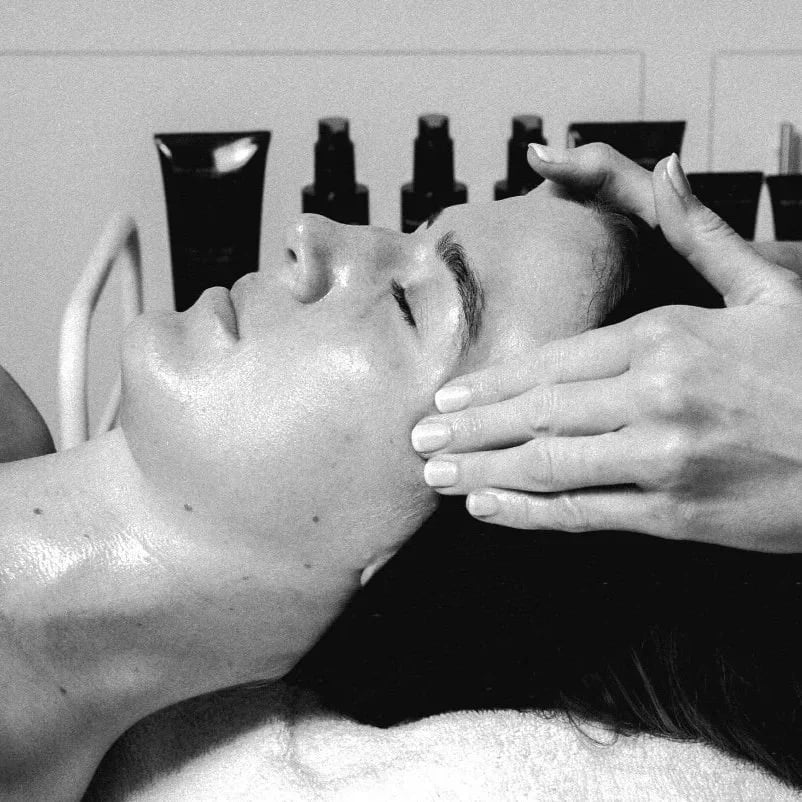 Milly's hands sculpting a client's face during The Amplified Facial.